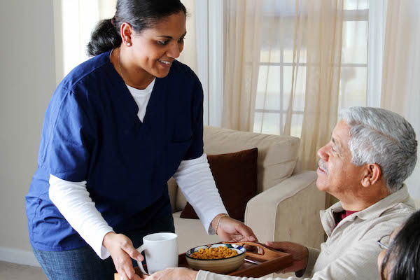 Home health care worker and an elderly couple